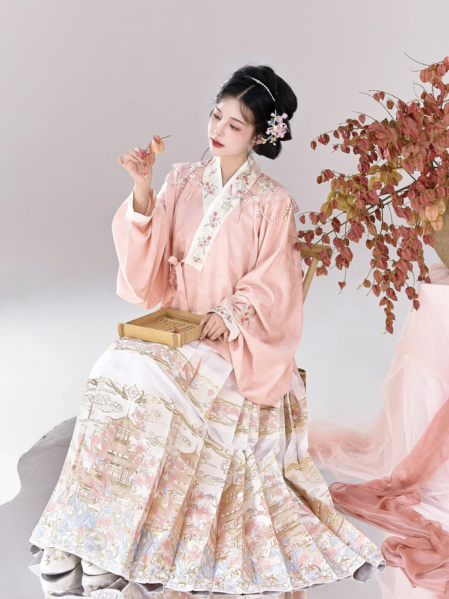 Side view of Ming Dynasty style pink embroidered pipa sleeve top with pleated landscape print mamianqun skirt