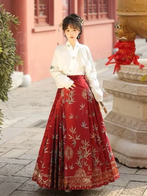 Full front view of red brocade mamianqun horse face skirt styled with an embroidered white Hanfu top and folding fan in a traditional Chinese palace street setting