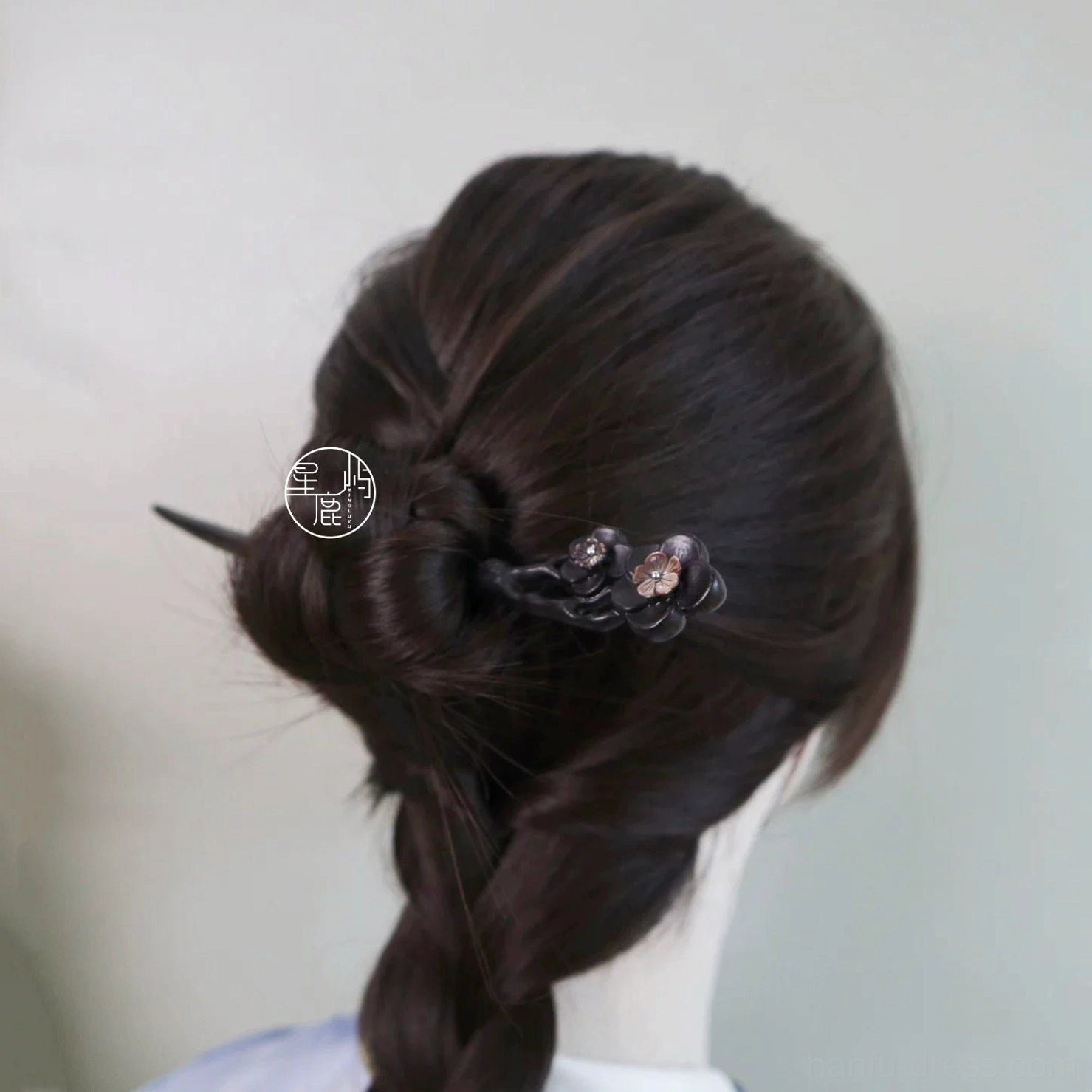 Minimalist dark plum flower Chinese hair stick displayed in a low braided updo, a refined traditional Hanfu hair accessory