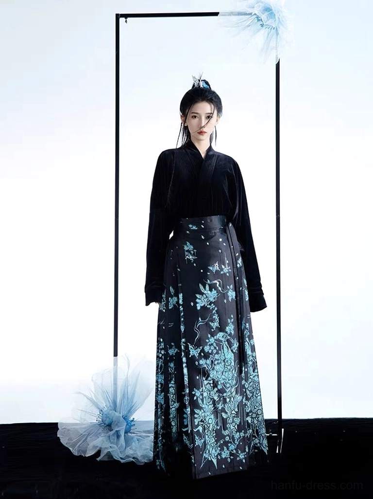 Minimalist modern Hanfu two-piece set featuring a fitted black velvet cross-collar top and tailored blue floral printed mamianqun horse face skirt