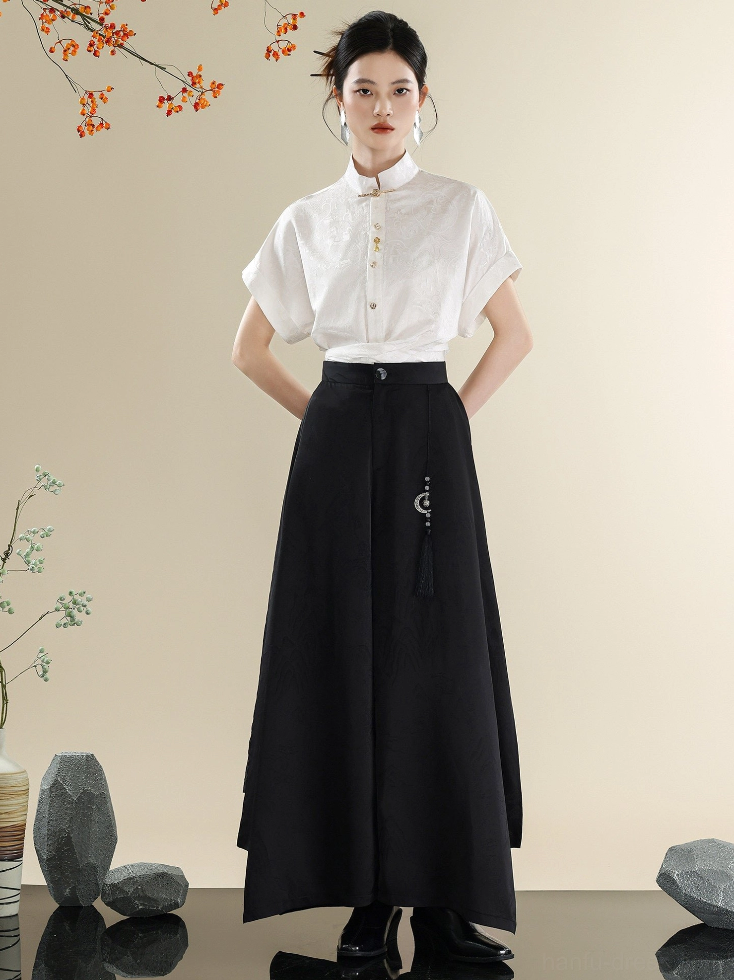 Minimalist white button-up Mandarin collar short-sleeve shirt paired with flowing black wide-leg trousers in a modern Hanfu outfit