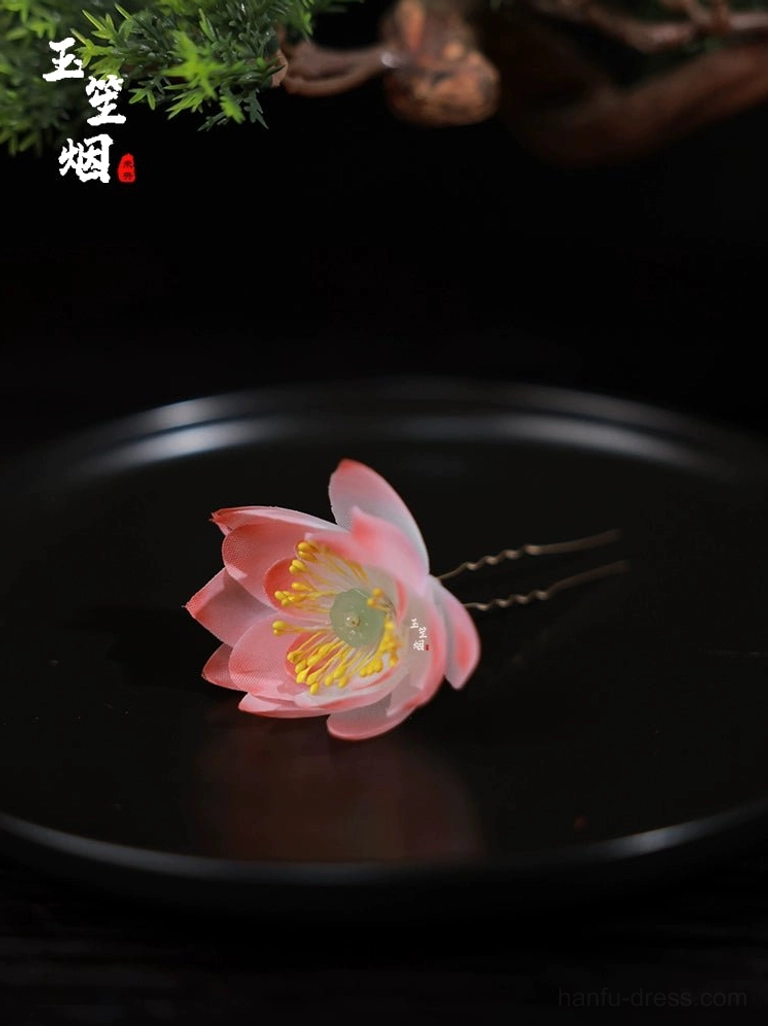 Minimalist translucent pink lotus flower hairpin with delicate petal texture and U-shaped base for Chinese-inspired hairstyles