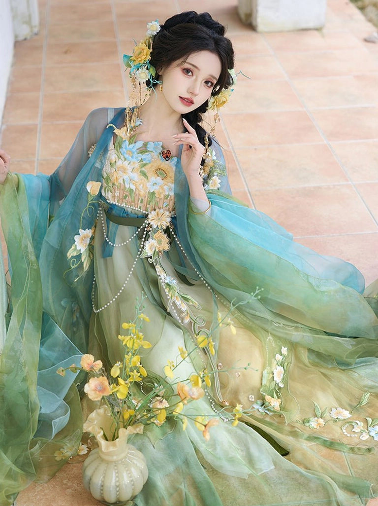 Tang Dynasty style Heziqun Hanfu dress in a kneeling pose, featuring a sheer outer coat, gradient skirt, floral embroidered bodice, and flower hairpins