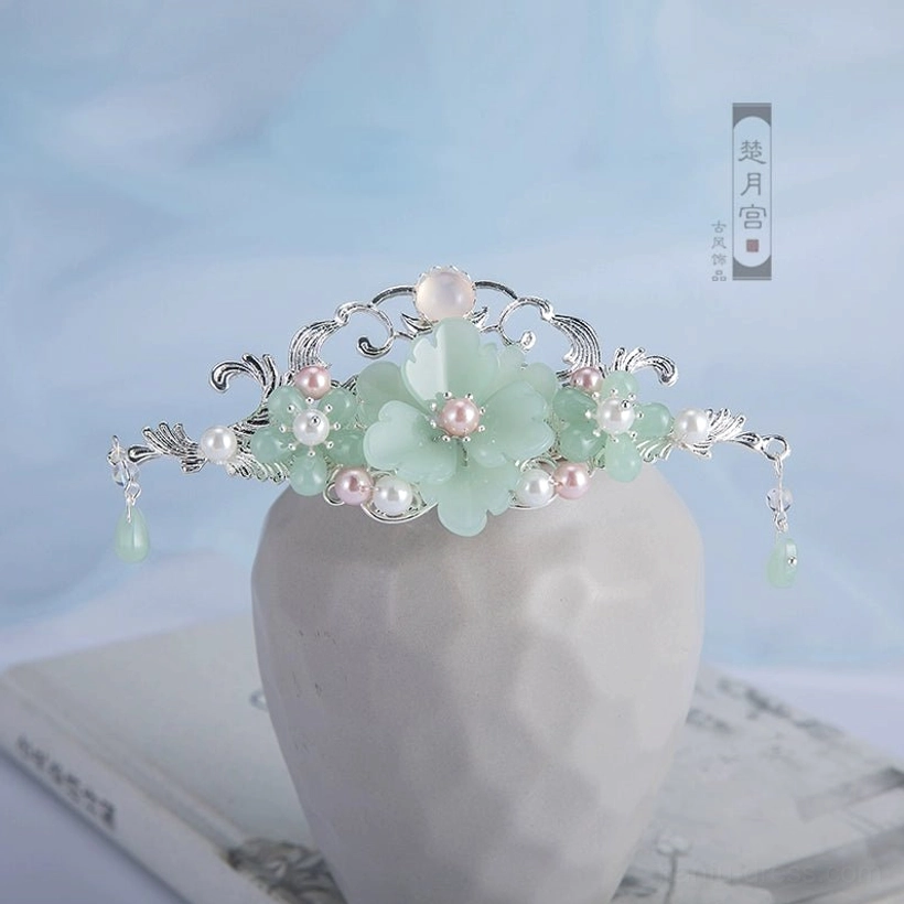 Mint green Hanfu hair accessory crown with large flower ornament, pink pearl-style center, silver filigree details, small beads, and hanging green tassels