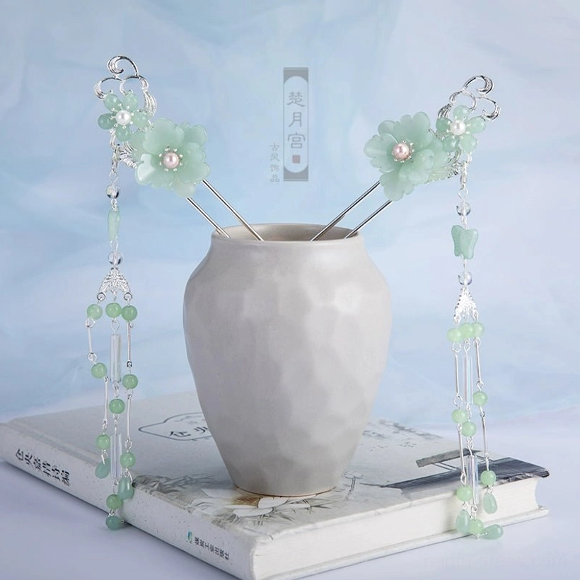 Two long mint green Hanfu tassel hair pins with flower ornaments, pink pearl-style centers, green beads, and decorative stone-style pendants