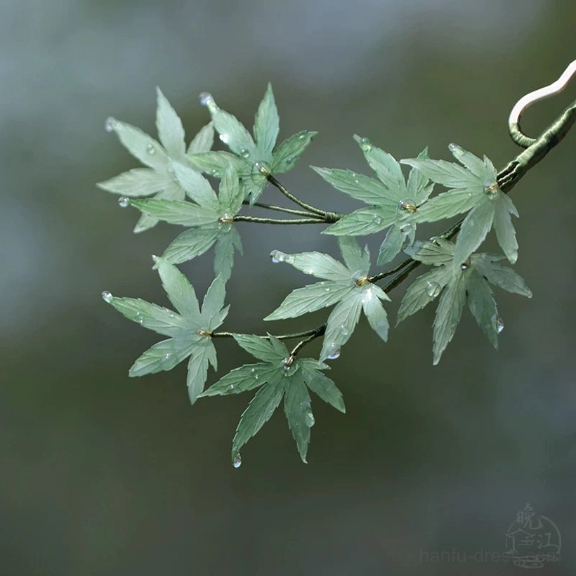 Front view of a mint green maple branch style Chinese hair stick with simulated water droplets and a dark green botanical stem