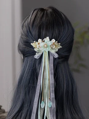 Mint green Snow Lotus Hanfu tassel back hairpin worn at the back of long dark hair with pearl flowers butterfly accents organza ribbons and water drop pendants