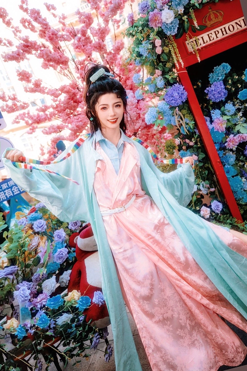 Side view of mint green Tang Dynasty Hanfu robe with wide sleeves layered over a peach pink jacquard dress and white waist belt