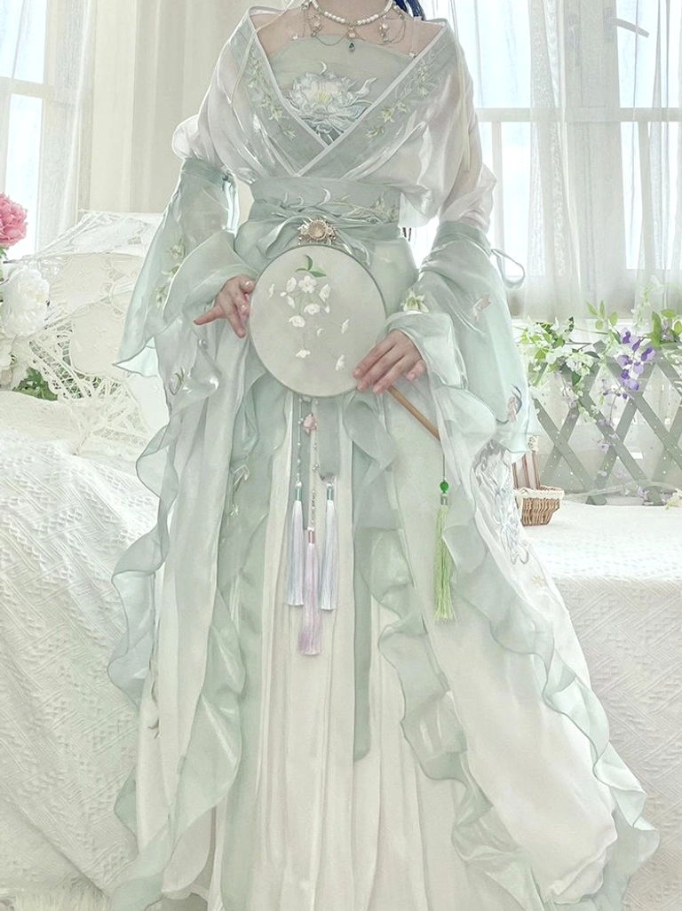 Detailed view of embroidered mint green Hanfu top and skirt with lavender tassel pendants floral silk fan and Wei Jin style silhouette