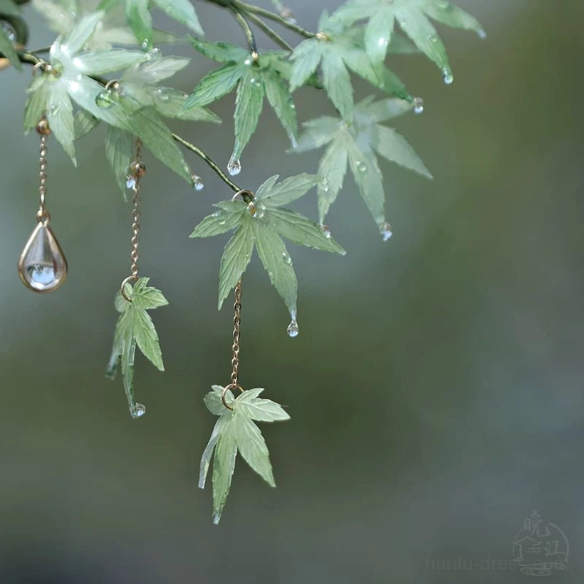 Top side view of a mint maple leaf Chinese hair accessory featuring two styles of tassels and water-droplet details on the leaves