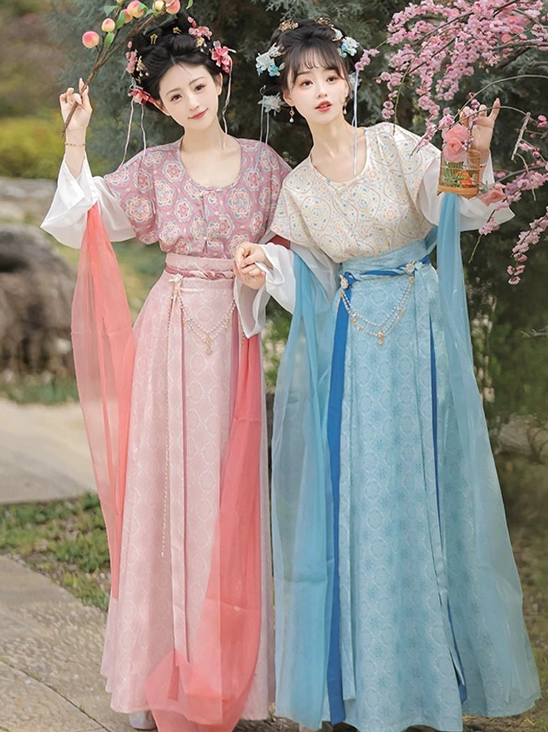 Tang Dynasty style round collar qiyao ruqun Hanfu outfits worn by models on a garden path with flowering trees