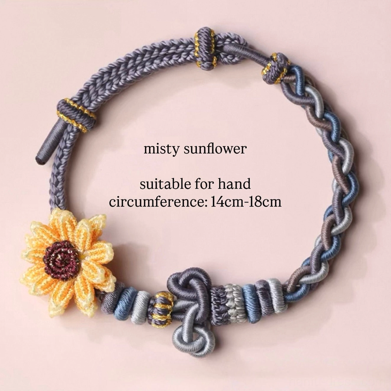 Misty sunflower handwoven Chinese knot bracelet with yellow crocheted flower charm gold thread decorative knots and pastel woven cords on light pink background
