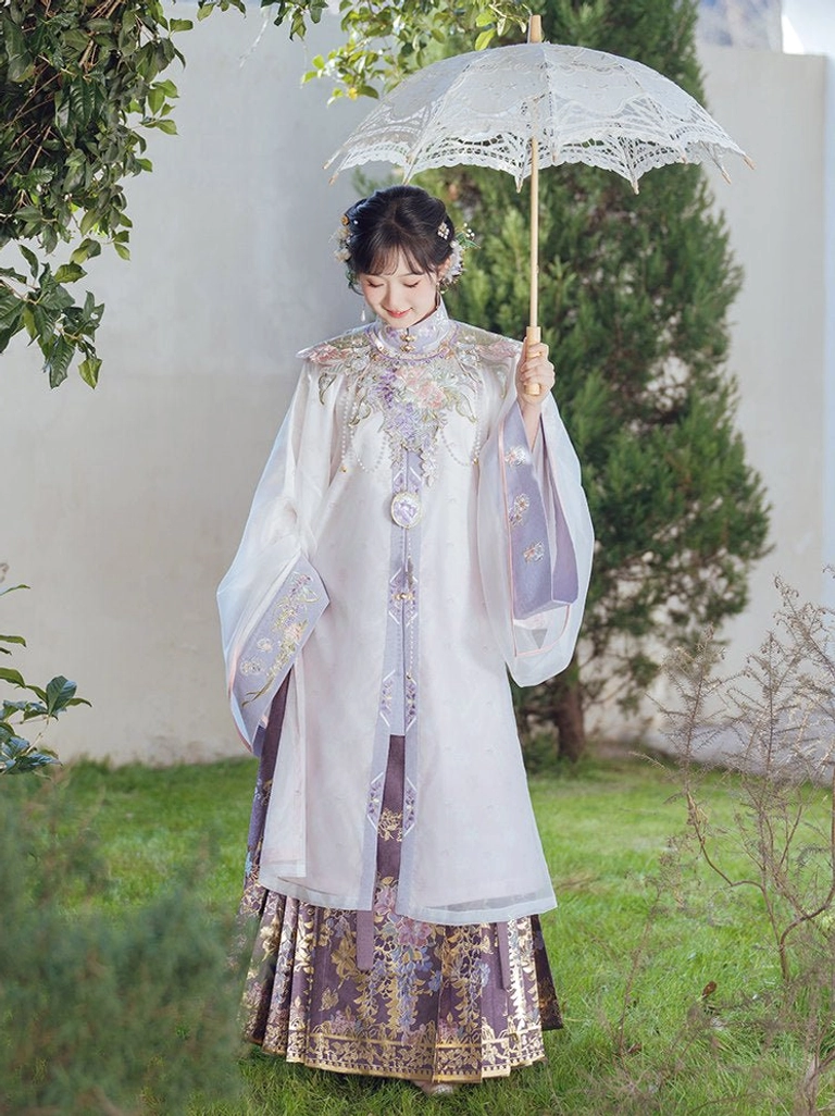 Outdoor full-length view of pale lilac Ming Dynasty Hanfu robe paired with violet floral mamian skirt in garden setting