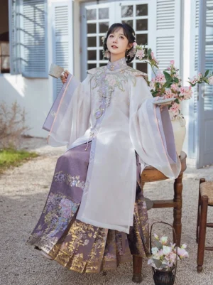 Three-quarter view of woman wearing Misty Vines Ming Dynasty Hanfu robe violet mamianqun skirt and floral hair accessories
