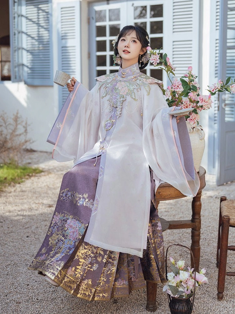 Three-quarter view of woman wearing Misty Vines Ming Dynasty Hanfu robe violet mamianqun skirt and floral hair accessories