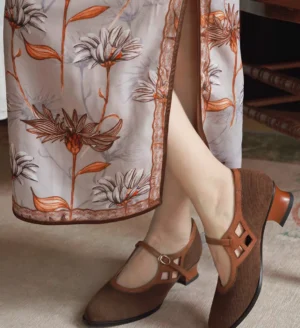 Mocha vintage Chinese traditional Mary Jane heels styled with a floral qipao dress, showing the retro pointed-toe silhouette and adjustable cutout ankle strap