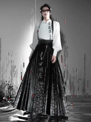 Full-body view of a modern calligraphy Hanfu outfit featuring a white long-sleeve top, black-and-white pleated mamianqun horse-face skirt, dark waist belt, and traditional Chinese ink-inspired styling