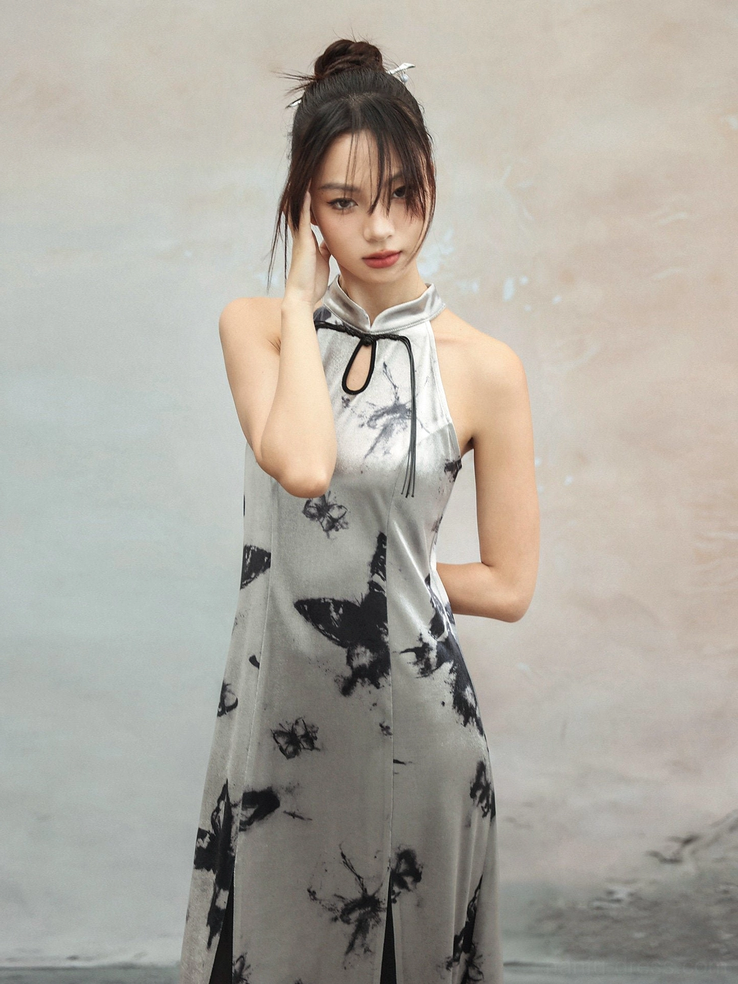 Close-up view of modern Chinese style halter cheongsam dress with stand collar, keyhole opening, tie closure, and black ink-wash butterfly print