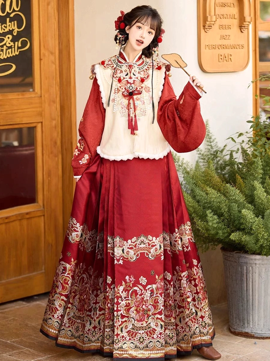 Front side view of modern Chinese Hanfu bridal outfit with layered auspicious embroidery, wine red mamianqun skirt, cream vest, and classic red and cream color palette
