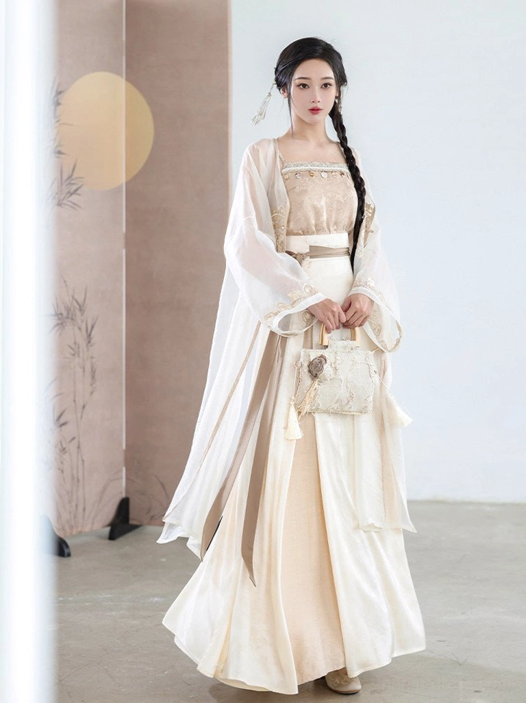 Front view of a modern Chinese style Hanfu outfit with champagne camisole, wide waist belt, flowing pleated skirt, sheer cardigan, and woven vintage handbag