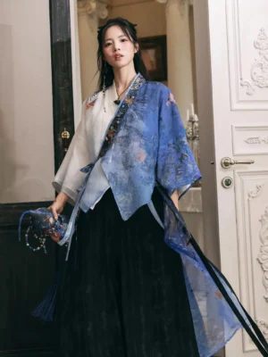 Front view of a modern Chinese Hanfu two-piece outfit with embroidered cross-collar trim, draped cardigan hem, and elegant tassel styling