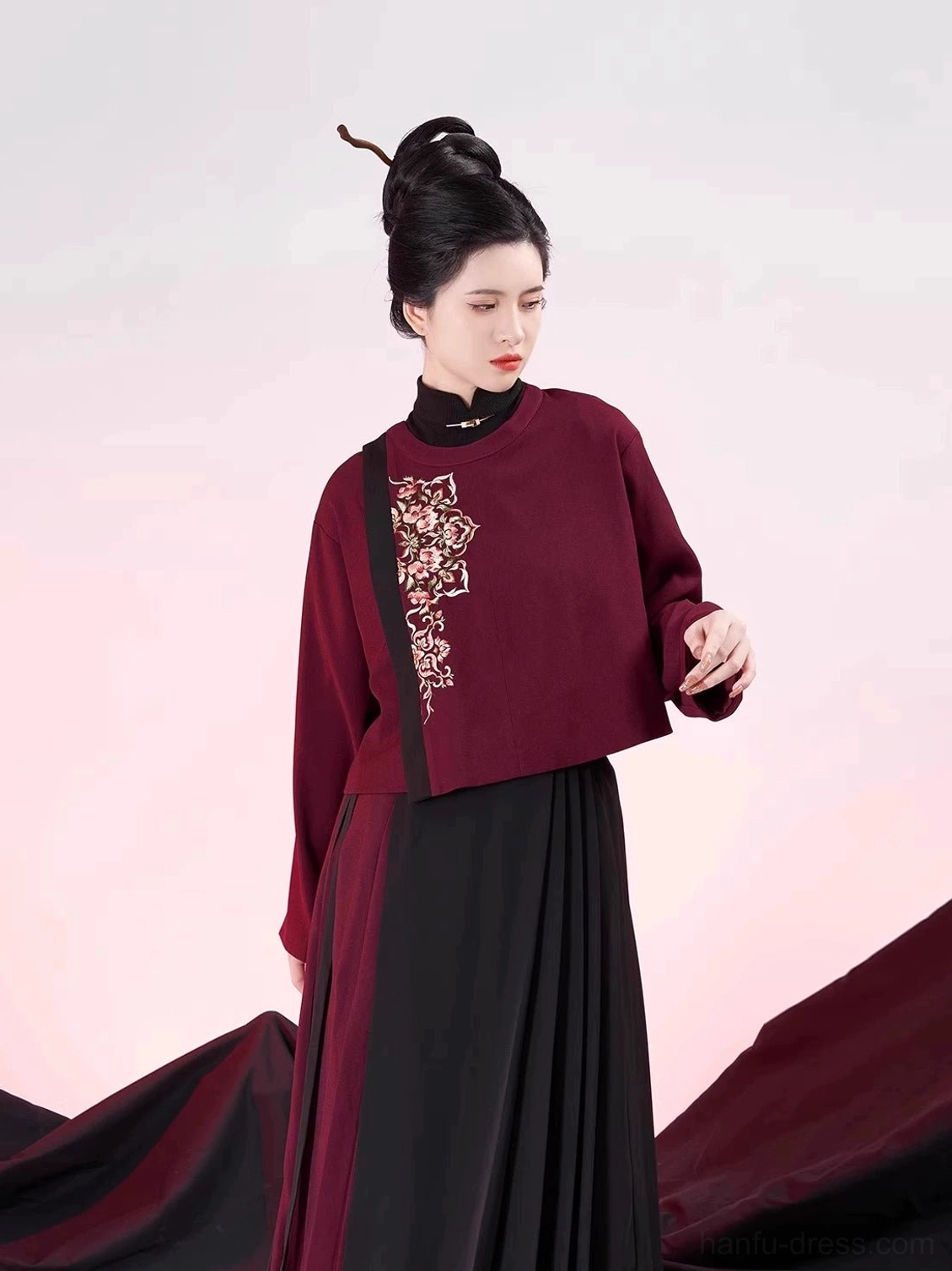 Full-body front view of a modern Chinese hanfu two-piece set with golden floral embroidery and elegant black and dark red pleated mamianqun-inspired lower piece