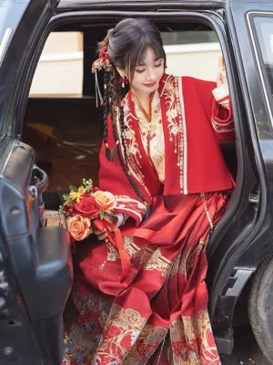 Modern Chinese Hanfu wedding outfit with crimson satin skirt and luxurious gold embroidered collar detail