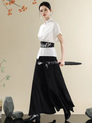 Three-quarter view of a modern Chinese clothing set with white stand collar shirt, black embroidered waist belt, wide-leg trousers, and black umbrella