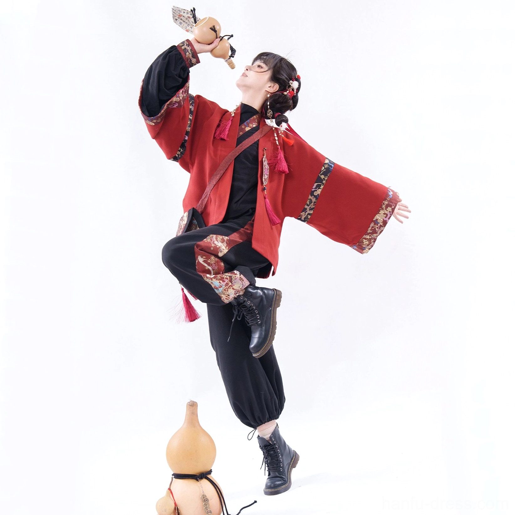 Modern Chinese New Year Hanfu set with red embroidered jacket, black wide-leg pants, traditional trims, and festive tassel accessories