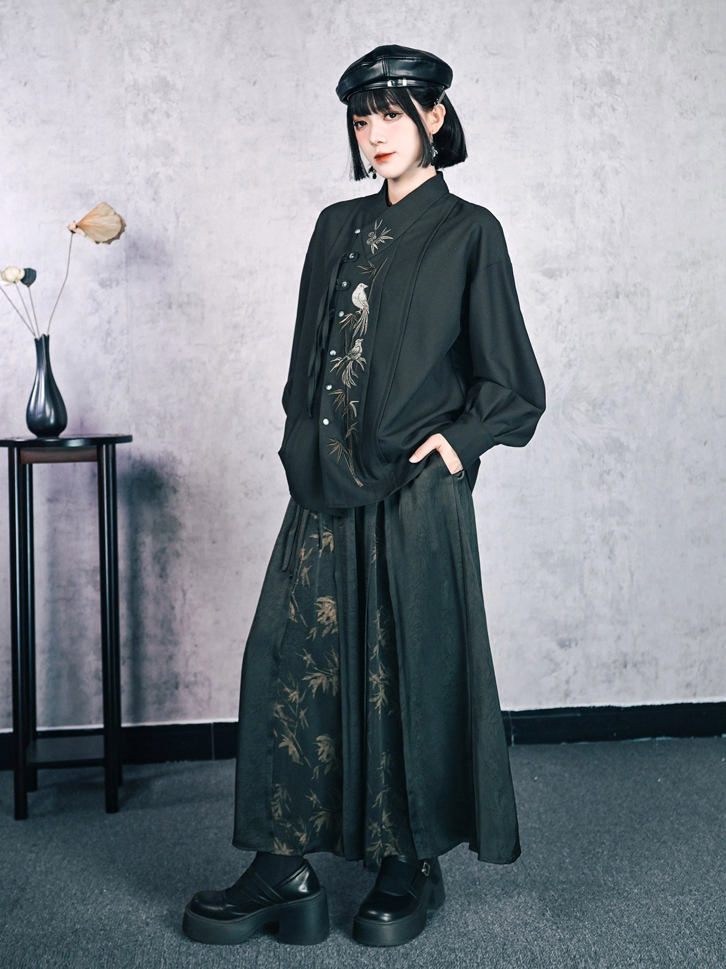 Modern Chinese style bamboo print high-waisted skirt paired with a stand-collar embroidered blouse, platform boots, and black beret