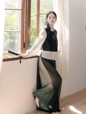 Side view of a contemporary Chinese style Hanfu outfit with deep green gradient wide leg pants and embroidered blouse in an elegant vintage interior