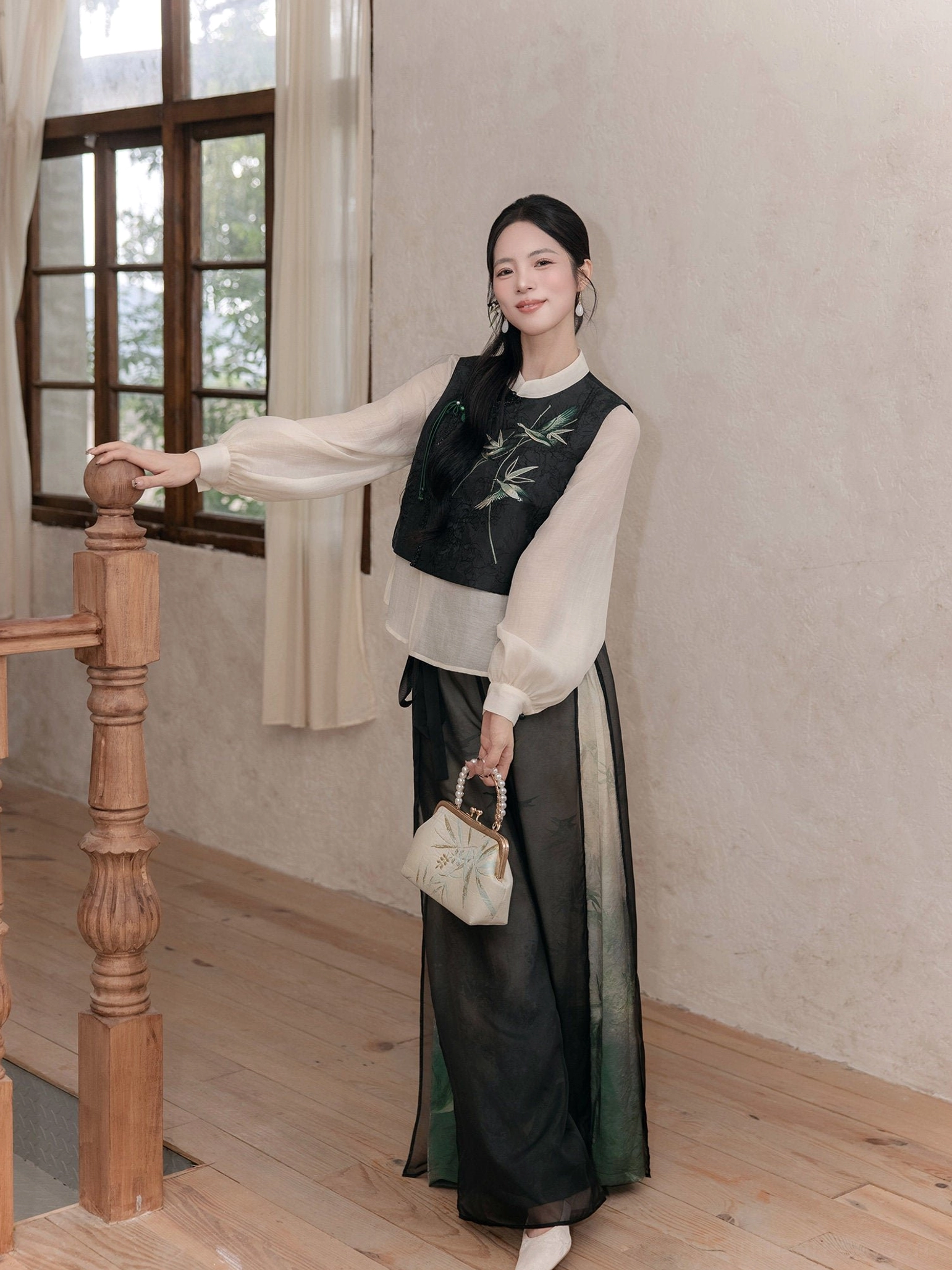 Side full-body view of a modern Chinese style Hanfu set displaying the relaxed drape and flowing silhouette of the ink-wash wide leg pants