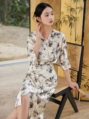 Modern Chinese style ink bamboo midi dress shown from three-quarter view with ruched high waist side slit skirt and flowing satin fabric