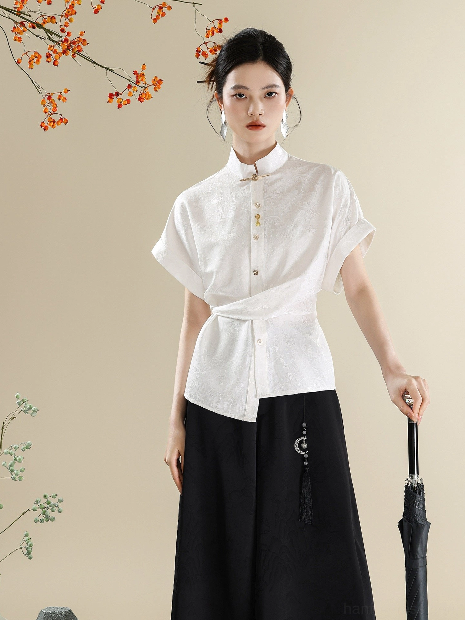 Front view of a modern Chinese style outfit featuring a white jacquard Mandarin collar shirt and plain black floor-length wide-leg trousers with metal tassel decor