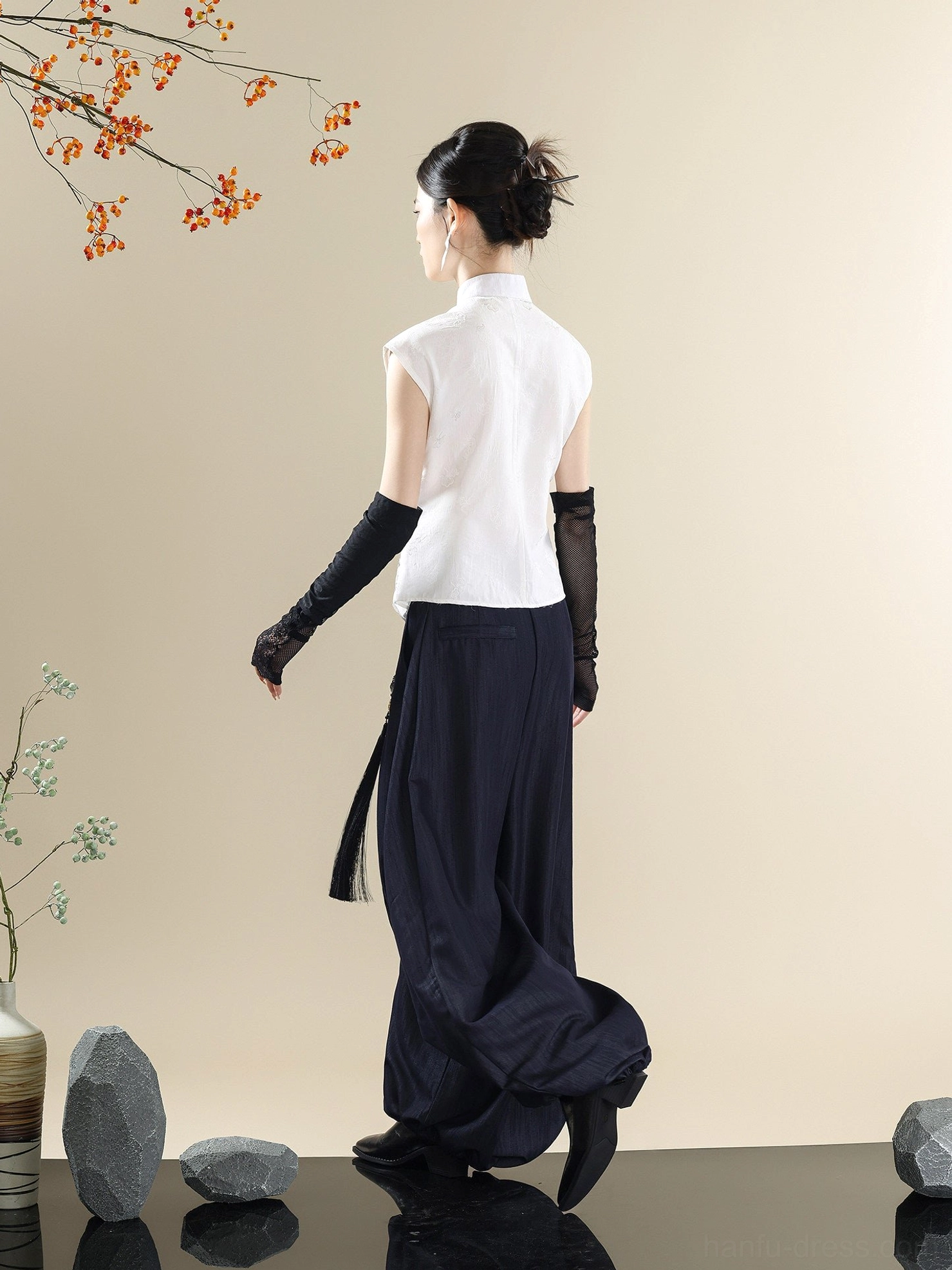 Back view of modern Chinese style Mandarin collar top and navy denim lantern pants with side tassel pendant