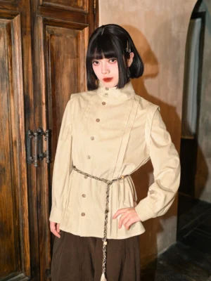Modern Chinese style stand collar double breasted beige long sleeve blouse with ribbed texture, styled with dark brown wide leg pants and tassel waist chain