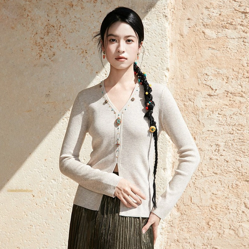 Apricot beige modern Hanfu V-neck knit sweater cardigan with jewel-inspired buttons styled with a dark brown pleated skirt