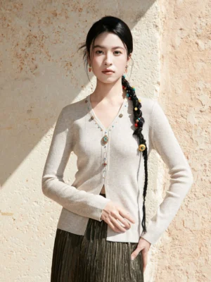 Apricot beige modern Hanfu V-neck cashmere-blend knit sweater with jewel buttons styled with a dark brown pleated skirt