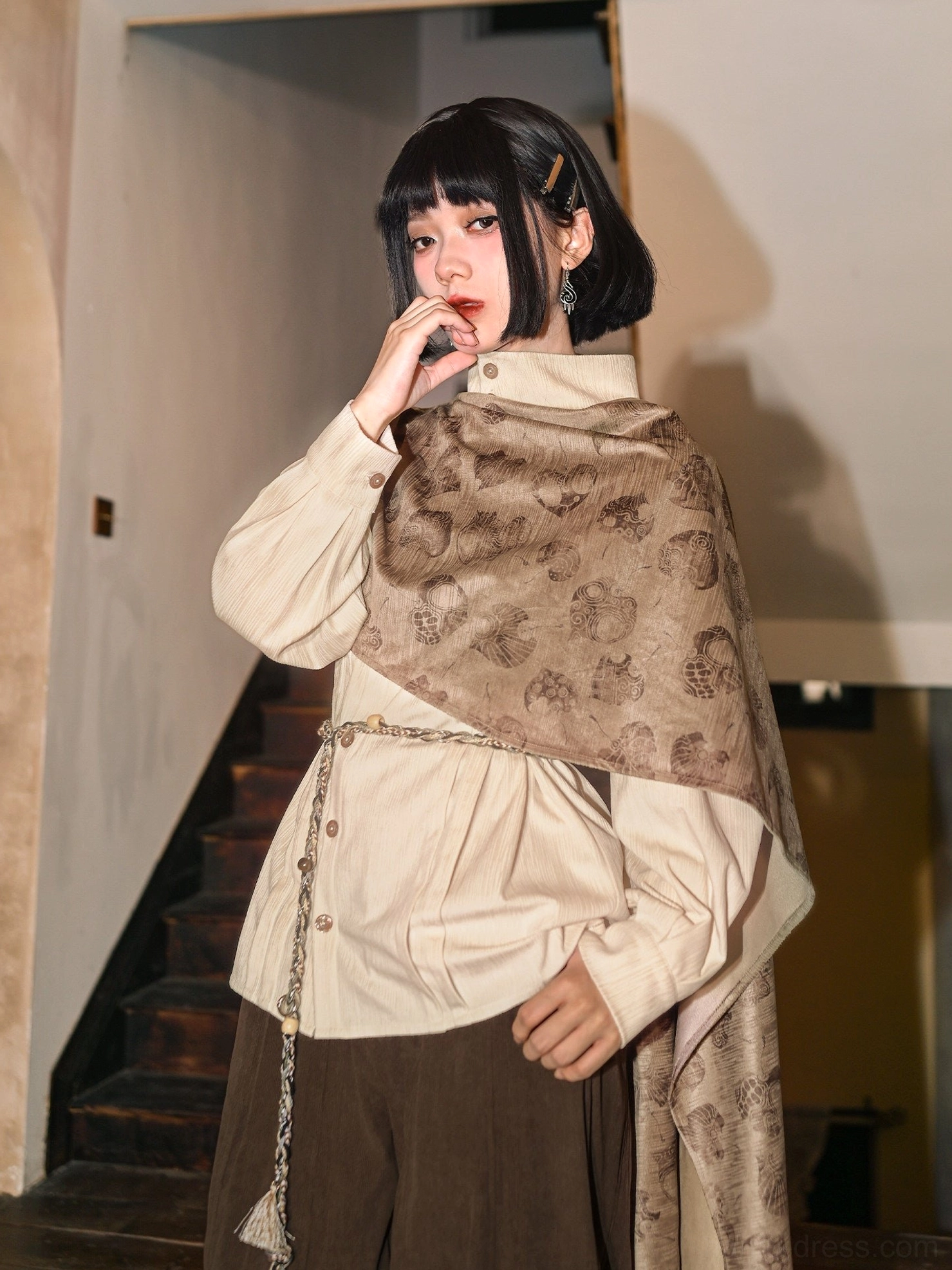 Side back view of a woman wearing a modern Hanfu blouse with flowing asymmetric printed detachable cape and decorative tassel waist chain