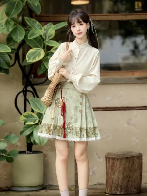 Modern Hanfu outfit featuring a beige ruffled stand-collar long-sleeve top, floral short mamianqun horse-face skirt, and matching red tassel detail in a vintage Chinese setting