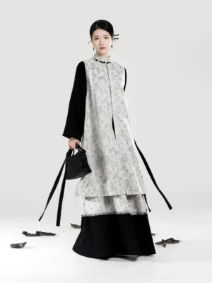 Modern Hanfu three-piece outfit with grey floral bijia vest black bow sleeve top and layered A-line skirt front view