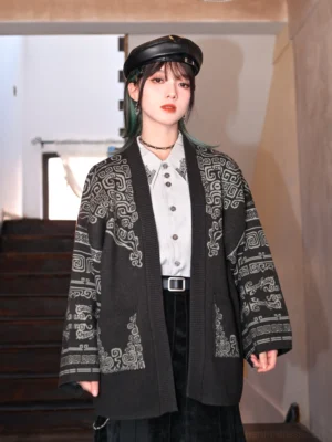 Front view of a black modern Hanfu bronze pattern knit cardigan sweater with light gray ancient Chinese bronze-inspired textures, loose drop shoulders, open front, and practical patch pockets