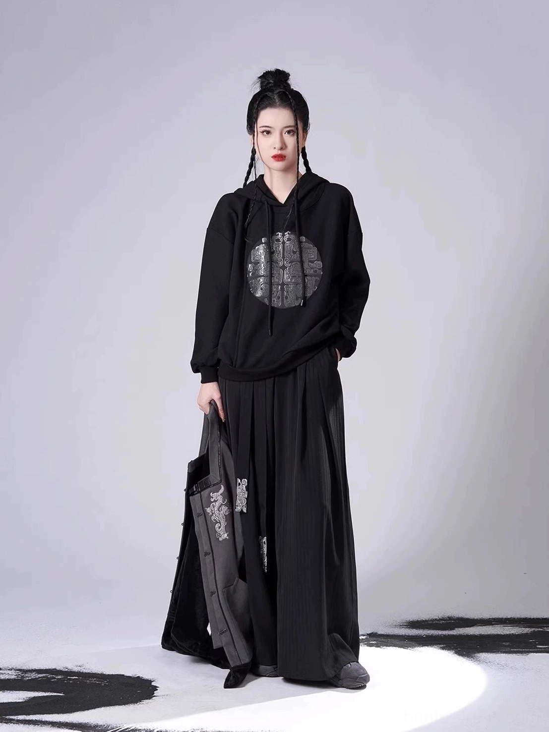 Front view of the black hooded sweater and high-waisted wide-leg pants from a modern Song Dynasty Hanfu clothing set