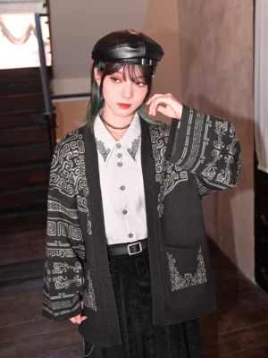 Three-quarter view of a Chinese-style bronze pattern cardigan worn over a collared shirt, showing the all-over ancient bronze-inspired texture and relaxed modern Hanfu silhouette