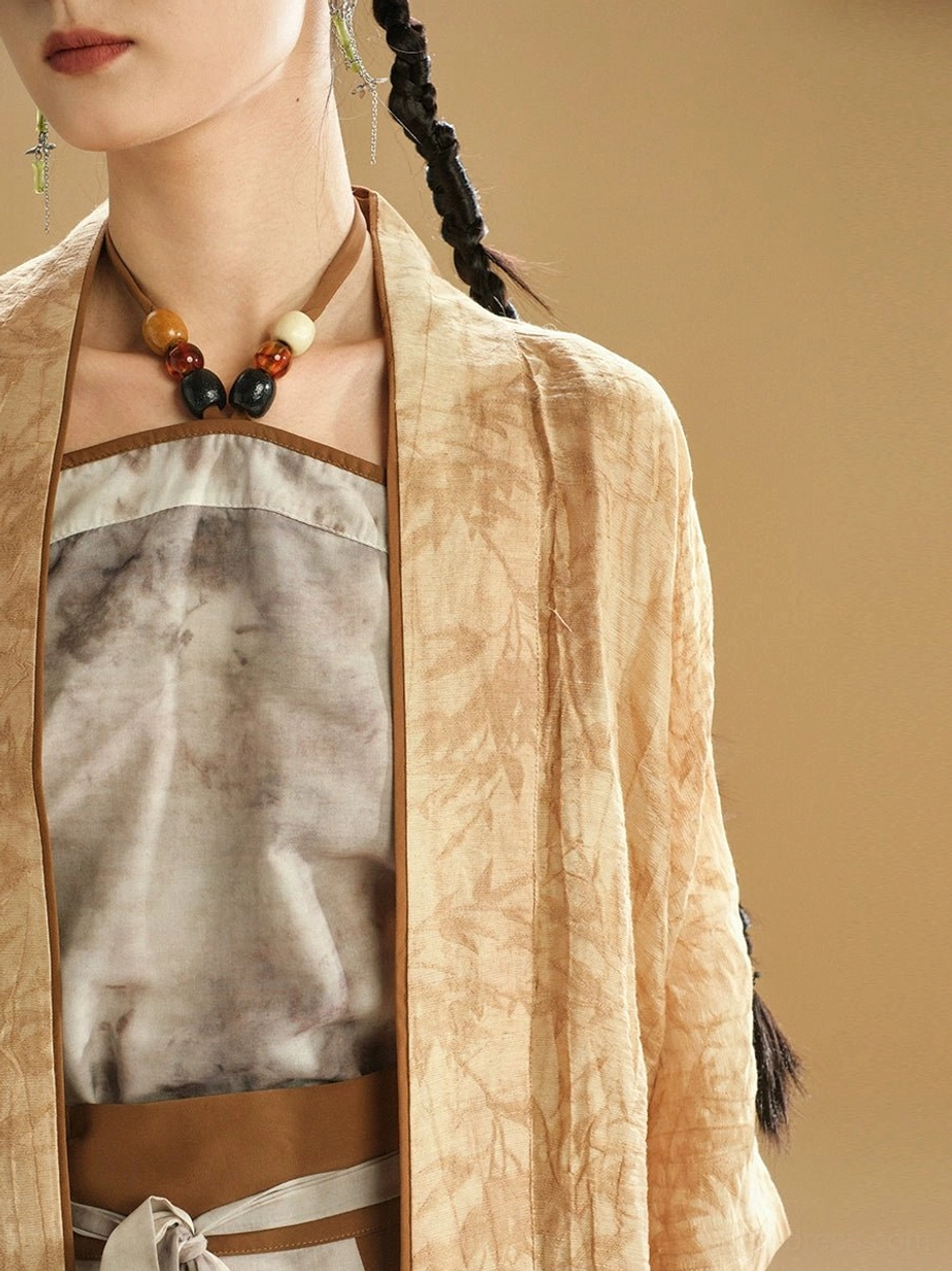 Close-up view of a modern Hanfu camisole and cardigan showing the contrasting brown neckline, textured outer fabric, and layered Chinese-inspired styling