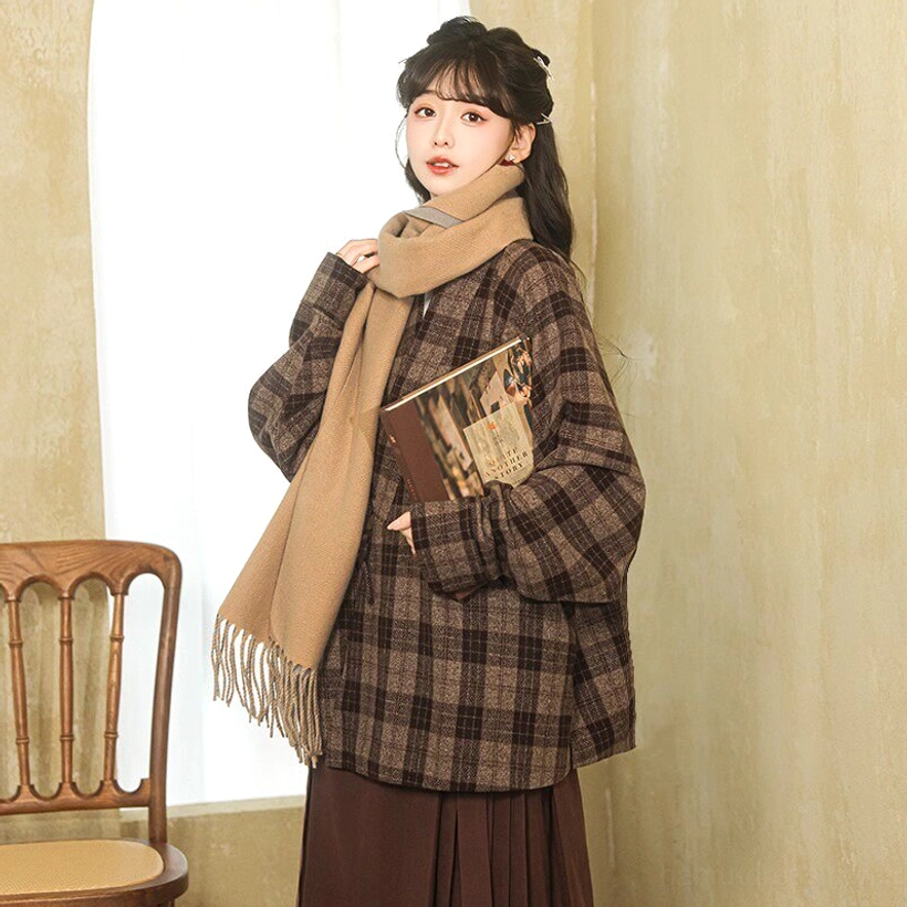 Modern Hanfu caramel dark plaid cross-collar wrap jacket upper view styled with a tassel scarf and vintage book