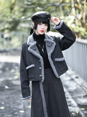 Dark charcoal grey modern Hanfu wool blend cropped jacket with lucky bat embroidery, textured collar and cuffs, styled with a black turtleneck and vintage cap