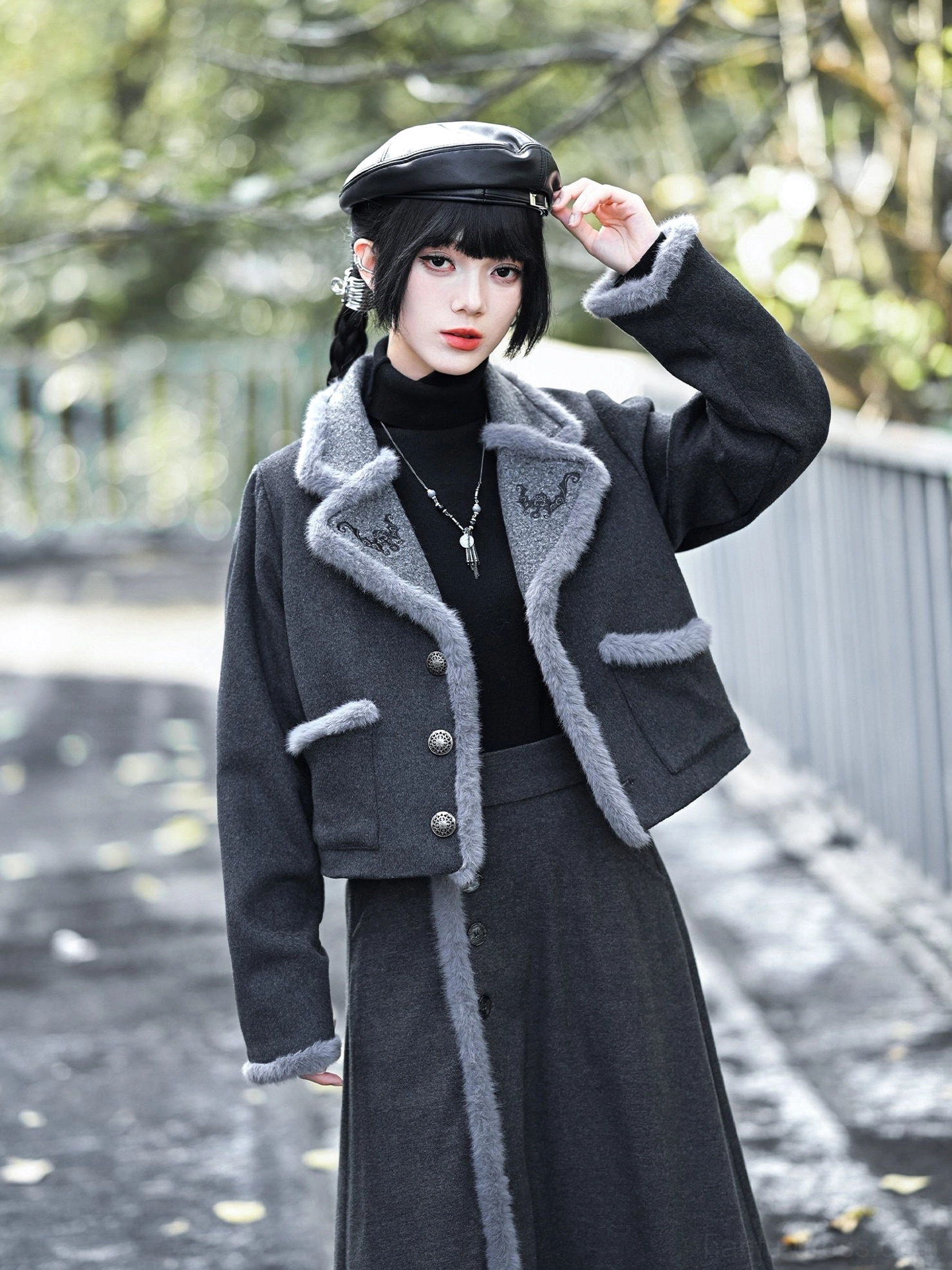Dark charcoal grey modern Hanfu wool blend cropped jacket with lucky bat embroidery, textured collar and cuffs, styled with a black turtleneck and vintage cap