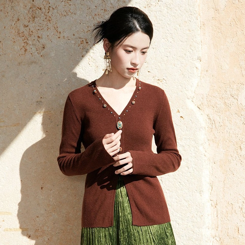 Chestnut brown modern Hanfu knit sweater with elegant V-neckline and decorative gem buttons styled with a green pleated long skirt