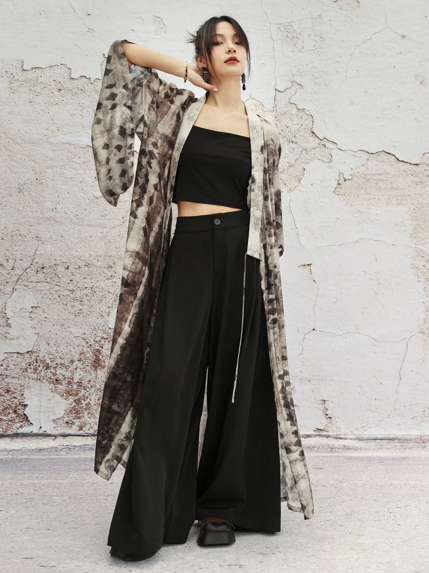 Three-quarter view of relaxed modern Hanfu cross collar cardigan worn over black cropped top and high waisted wide leg pants